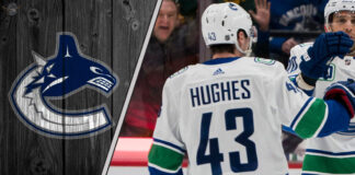 Vancouver Canucks captain Quinn Hughes looks on during a game, representing the focus of current NHL trade rumors