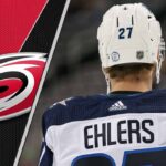 Nikolaj Ehlers in a Carolina Hurricanes jersey, celebrating a goal, to illustrate his projected fantasy hockey point increase for the 2025-2026 NHL season.