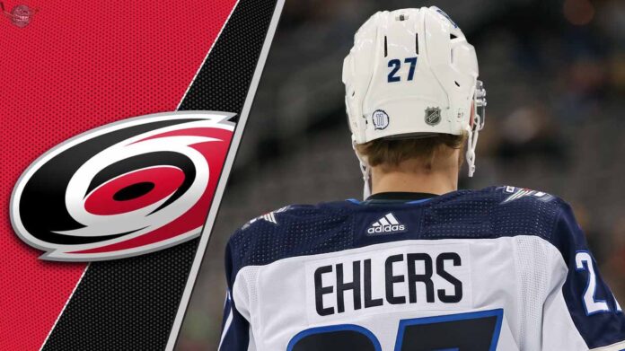 Nikolaj Ehlers in a Carolina Hurricanes jersey, celebrating a goal, to illustrate his projected fantasy hockey point increase for the 2025-2026 NHL season.