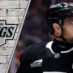 A focused Anže Kopitar skating in his Los Angeles Kings jersey during an NHL game, ready to make a play.