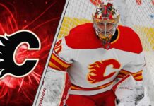 Calgary Flames goalies Devin Cooley making a save as he battles for the back-up goalie job