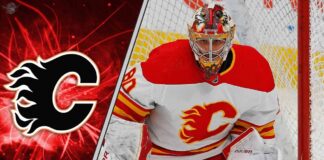 Calgary Flames goalies Devin Cooley making a save as he battles for the back-up goalie job