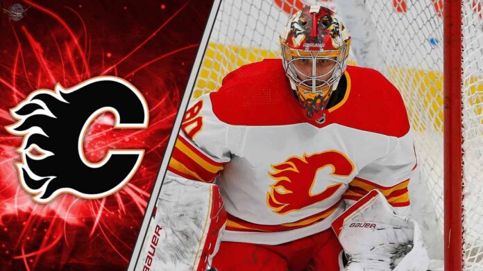 calgary-flames-goalies-devin-cooley-ivan-prosvetov-preseason Calgary Flames goalies Devin Cooley making a save as he battles for the back-up goalie job