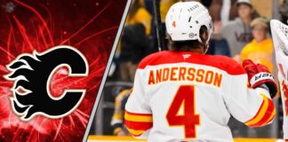 Calgary Flames defenseman Rasmus Andersson looks on during an NHL game, as NHL trade rumors swirl about his future with the team.