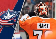 Goaltender Carter Hart in his Philadelphia Flyers jersey, looking focused during a game, as he's rumored to be signing with the Columbus Blue Jackets.