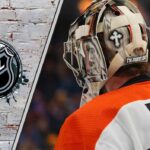 Goaltender Carter Hart in his Flyers uniform, focused and looking on during a game.