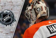 Goaltender Carter Hart in his Flyers uniform, focused and looking on during a game.