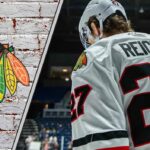 Chicago Blackhawks forward Lukas Reichel skates during an NHL game, looking to prove his value amidst recent NHL rumors