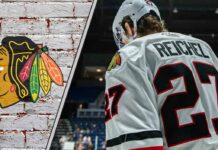 Chicago Blackhawks forward Lukas Reichel skates during an NHL game, looking to prove his value amidst recent NHL rumors