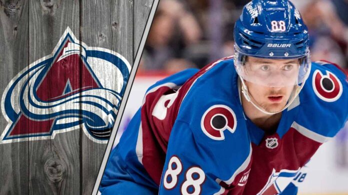 Colorado Avalanche center Martin Necas skating during a game, looking focused. The background shows the crowd and arena lights.