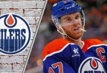 dmonton Oilers captain Connor McDavid looks on thoughtfully during a game, contemplating his future with the team and a potential move to the Toronto Maple Leafs.