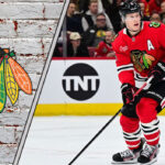 Chicago Blackhawks defenseman Connor Murphy skates during an NHL game, with the Blackhawks logo visible in the background, sparking NHL trade rumors discussions.
