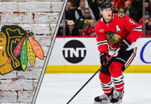 Chicago Blackhawks defenseman Connor Murphy skates during an NHL game, with the Blackhawks logo visible in the background, sparking NHL trade rumors discussions.