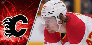 Calgary Flames forward Connor Zary skates with the puck during an NHL game, focused on the play.