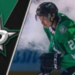 Dallas Stars forward Jason Robertson skates with the puck during an NHL game, focused on the play.