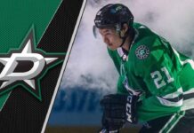 Dallas Stars forward Jason Robertson skates with the puck during an NHL game, focused on the play.