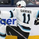 Utah Mammoth forward Dylan Guenther celebrating a goal during an NHL game, poised for his 2025-26 breakout season.