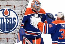 Edmonton Oilers goalies Stuart Skinner and Calvin Pickard hug each other during an NHL game, contemplating the team's championship hopes and pressure.