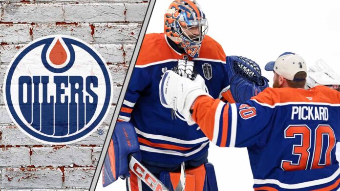 edmonton-oilers-goalie-stuart-skinner-contemplating Edmonton Oilers goalies Stuart Skinner and Calvin Pickard hug each other during an NHL game, contemplating the team's championship hopes and pressure.