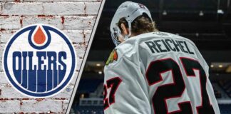 Chicago Blackhawks forward Lukas Reichel skates with his head down thinking about the latest NHL trade rumors about him