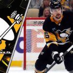 ittsburgh Penguins defenseman Erik Karlsson skates with the puck during an NHL game.