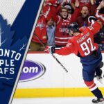 Evgeny Kuznetsov celebrates a goal, with the logo of the Toronto Maple Leafs visible in the background, representing his potential NHL return.