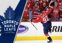 Evgeny Kuznetsov celebrates a goal, with the logo of the Toronto Maple Leafs visible in the background, representing his potential NHL return.