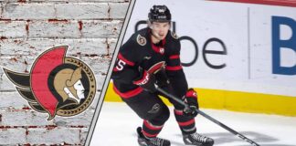 Ottawa Senators defenseman Jake Sanderson skating with the puck during an NHL game, ready to make a play.