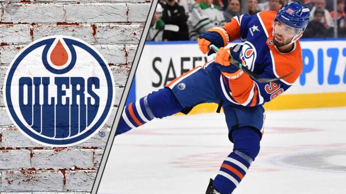 Edmonton Oilers defenseman Jake Walman skating with the puck during an NHL game.