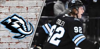 Logan Cooley #92 of the Utah Mammoth skates with the puck during a game, poised for a breakout 2025-26 NHL season with projected 77 points
