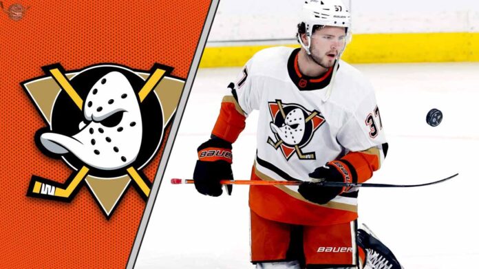 Anaheim Ducks center Mason McTavish skates with the puck during an NHL game, with the Ducks logo visible on his jersey.