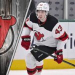 The Clock is Ticking: Why the Luke Hughes Contract Saga Could Define the New Jersey Devils’ Future New Jersey Devils defenseman Luke Hughes skates with the puck during an NHL game, with the Devils logo in the background.