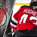New Jersey Devils and Luke Hughes: A Deep Dive into the Contract Stalemate New Jersey Devils defenseman Luke Hughes skating with the puck during an NHL game, illustrating his contract negotiation stalemate with the team.