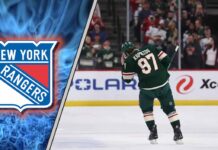 Kirill Kaprizov in his Minnesota Wild jersey with the New York Rangers logo to the left as NHL trade rumors swirl around him