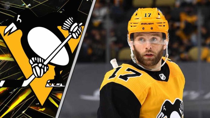 Pittsburgh Penguins forward Bryan Rust skates with the puck during an NHL game, with trade rumors swirling about his future with the team.