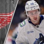 Quinn Hughes to the Red Wings? The Truth Behind the Rumors Detroit Red Wings logo with a picture of Quinn Hughes symbolizing a potential trade.