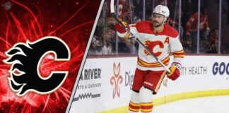 Calgary Flames defenseman Rasmus Andersson looks on during a game, with his contract situation and future with the team in question.