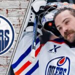 Edmonton Oilers goalie Stuart Skinner standing in his goal crease with his goalie mask off thinking about his next contract