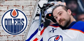Edmonton Oilers goalie Stuart Skinner standing in his goal crease with his goalie mask off thinking about his next contract
