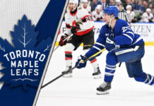 Toronto Maple Leafs defenseman Brandon Carlo skates during an NHL game, representing a key trade chip for the team's forward hunt.