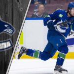 Vancouver Canucks captain Quinn Hughes skating during an NHL game, looking focused on the play