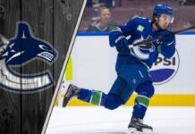 Vancouver Canucks captain Quinn Hughes skating during an NHL game, looking focused on the play