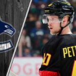 Can Elias Pettersson Silence the Doubters and Reclaim His Superstar Status? Vancouver Canucks forward Elias Pettersson skates with the puck during an NHL game, focused and determined.
