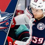 Columbus Blue Jackets forward Yegor Chinakhov skates during a game, with the team's logo visible in the background.
