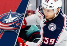 Columbus Blue Jackets forward Yegor Chinakhov skates during a game, with the team's logo visible in the background.