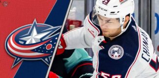 Columbus Blue Jackets forward Yegor Chinakhov skates during a game, with the team's logo visible in the background.