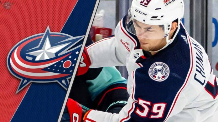 yegor-chinakhov-columbus-blue-jackets-trade-rumors-2025 Columbus Blue Jackets forward Yegor Chinakhov skates during a game, with the team's logo visible in the background.