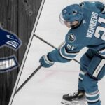 Alex Wennberg skating in a San Jose Sharks jersey, being scouted as a trade target for the Vancouver Canucks.