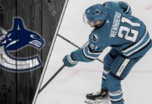 Alex Wennberg skating in a San Jose Sharks jersey, being scouted as a trade target for the Vancouver Canucks.