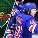 New York Rangers forward Artemi Panarin celebrates a goal, with a Minnesota Wild logo featured prominently, representing a major NHL trade rumor.